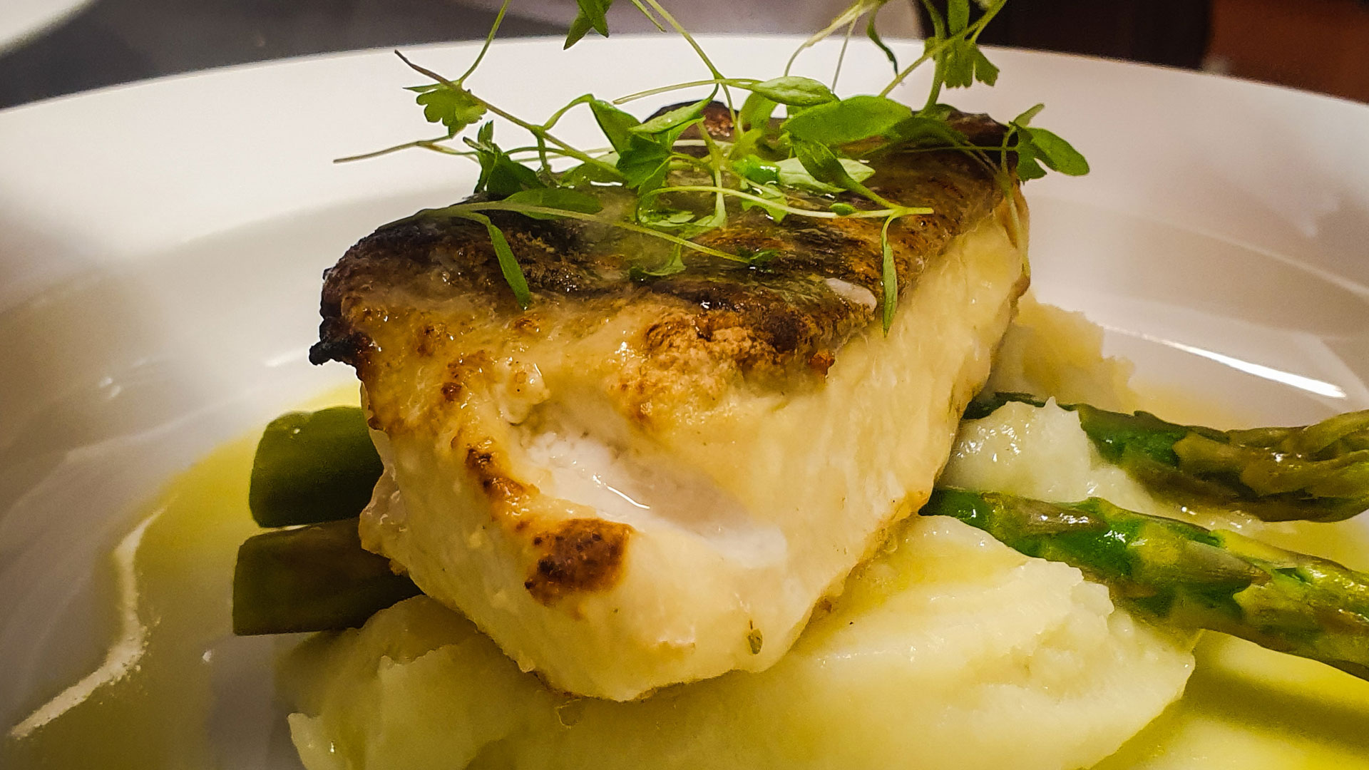 Pan fried sea bass fillet with asparagus and lemon butter sauce